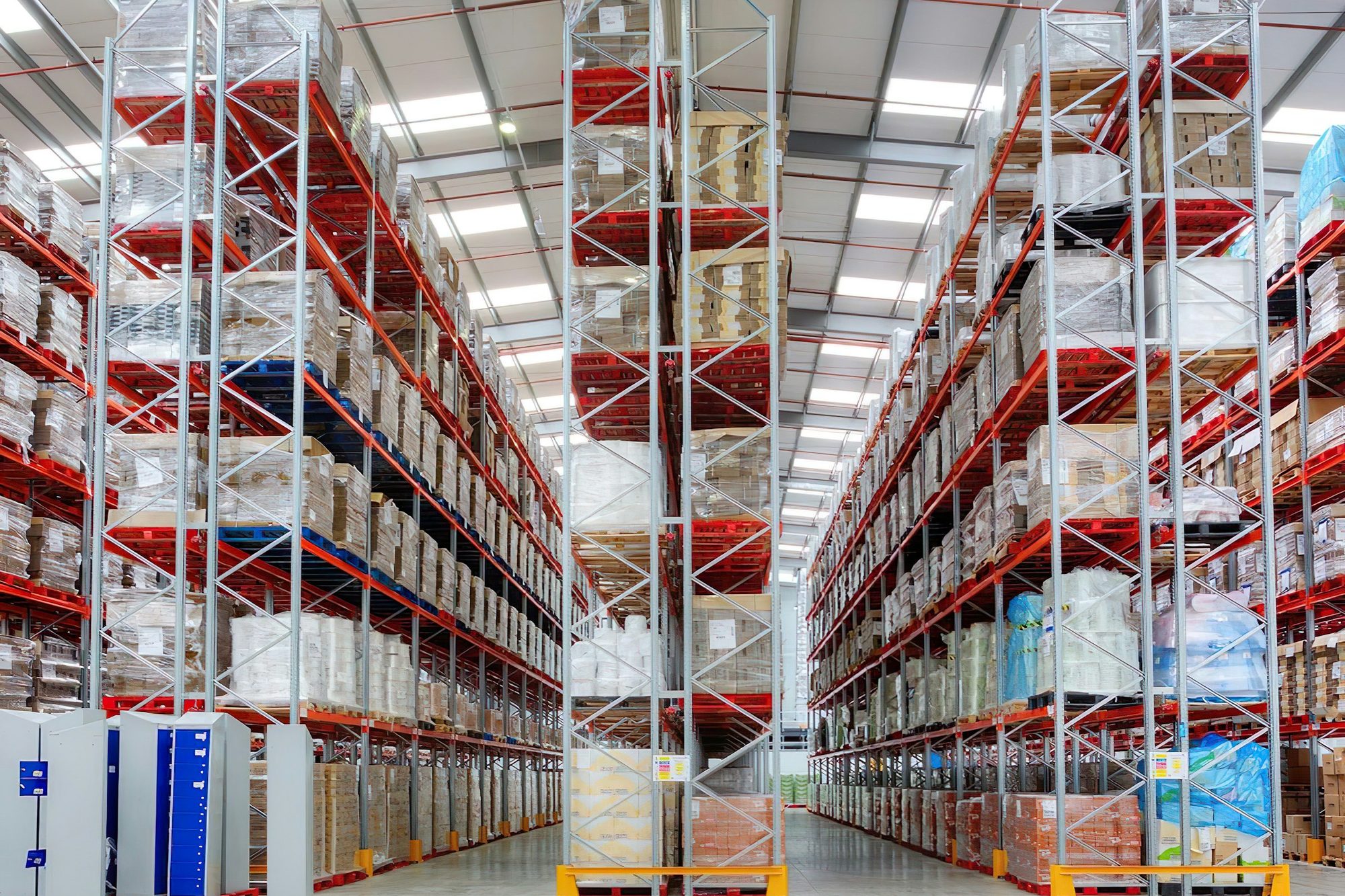 Fully loaded pallet racking in a bright distribution center